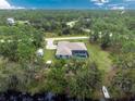 House with a pool and detached shed, surrounded by lush greenery at 27545 Monte Cristo Blvd, Punta Gorda, FL 33955