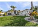 Attractive landscaping with a variety of plants and palm trees at 17466 Fuego Ln, Punta Gorda, FL 33955