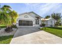 Charming curb appeal with lush landscaping and palm trees at 17466 Fuego Ln, Punta Gorda, FL 33955