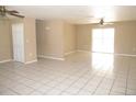 Spacious living room with tile floors and ceiling fans at 21471 Dranson Ave, Port Charlotte, FL 33952