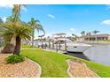 Waterfront home with private boat dock and canal access, surrounded by lush palms at 3948 La Costa Island Ct, Punta Gorda, FL 33950