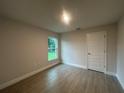 Cozy bedroom featuring sleek wood-look tile flooring and a bright window offering serene outdoor views at 507 San Ambrosio St, Punta Gorda, FL 33983