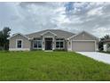 Charming single-story home with a manicured lawn and neutral paint scheme, complemented by an attached two-car garage at 507 San Ambrosio St, Punta Gorda, FL 33983