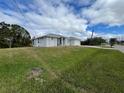 Single-story home on a grassy lot under a blue sky at 200 Dolphin Pkwy, Punta Gorda, FL 33950