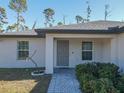 Gray front door and walkway leading to the house entrance at 2364 Hagerick Ln, North Port, FL 34288