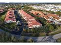 Community of townhouses with red tile roofs and lush landscaping at 240 W End Dr # 311, Punta Gorda, FL 33950