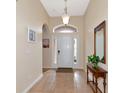 Bright and airy foyer with tile flooring and a wooden console table at 2507 Hobblebrush Dr, North Port, FL 34289
