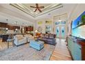 Open concept living room with high ceilings and views to the pool at 31 Tee View Pl, Rotonda West, FL 33947