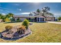 Single-story home with attached two-car garage and landscaped front yard at 3404 Depew Ave, Port Charlotte, FL 33952