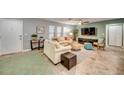 Living room with two sofas, ceiling fan, and large TV at 3404 Depew Ave, Port Charlotte, FL 33952