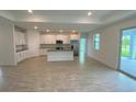 Bright and spacious kitchen with white shaker cabinets, a large island, and stainless steel appliances at 384 Prineville St, Port Charlotte, FL 33954