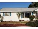 Charming single-story home with manicured lawn and freshly painted white exterior, complete with pleasant landscaping at 806 Hickory Ln, Bradenton, FL 34208