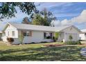 Single-story home with landscaping, white siding, and peach shutters at 806 Hickory Ln, Bradenton, FL 34208