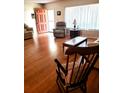 Inviting living area featuring hardwood floors, large windows, and comfortable seating at 806 Hickory Ln, Bradenton, FL 34208