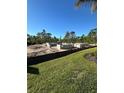 A new home under construction with cinder block walls and surrounding trees and landscaping at 8161 Dressel St, Port Charlotte, FL 33981