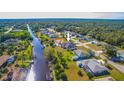 Aerial view of canal-front property with spacious lot and surrounding homes at 158 Eppinger Dr, Port Charlotte, FL 33953