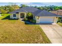 Single-story home with a two-car garage and well-maintained lawn at 158 Eppinger Dr, Port Charlotte, FL 33953