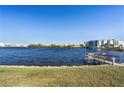 Scenic waterfront view with a private dock, calm water, and distant buildings at 1780 Deborah Dr # 6, Punta Gorda, FL 33950