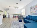 Bright living room featuring a blue sofa and a decorative area rug at 1796 Scarlett Ave, North Port, FL 34289