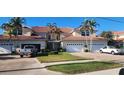Townhome exterior with tile roof, attached two-car garages, and landscaped yard at 197 Tropicana Dr # 1512, Punta Gorda, FL 33950