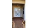 Covered front entry with white double doors, brick walkway, and side window at 197 Tropicana Dr # 1512, Punta Gorda, FL 33950