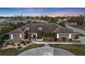 A beautiful one story home at dusk featuring a concrete walkway, desert landscaping, and a prominent front entrance at 23309 Hartley Ave, Port Charlotte, FL 33954