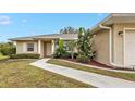 Front exterior view of a single-story home with a walkway leading to the entrance at 26090 Huanuco Dr, Punta Gorda, FL 33983