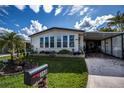 Mobile home exterior with a well-manicured lawn at 368 Catamaran Ct, North Port, FL 34287