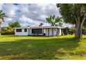 Front exterior of a white single-story home with black shutters and a covered entryway at 433 W Grace St, Punta Gorda, FL 33950