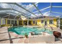 Spacious screened-in pool and spa with a large paved deck at 1064 Harbour Way Pl, Punta Gorda, FL 33983