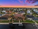 Waterfront property showcasing private boat dock and expansive backyard in a coastal community with surrounding canals at 1422 Kittiwake Dr, Punta Gorda, FL 33950