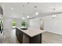 Open concept kitchen with an island and stainless steel appliances at 18854 Ackerman Ave, Port Charlotte, FL 33948