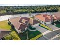 High-angle view of home and neighboring properties nestled along a canal at 1946 Cove Pointe Dr, Venice, FL 34293