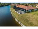 Waterfront home with seawall, screened lanai, and pool at 1946 Cove Pointe Dr, Venice, FL 34293