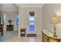 Bright entryway with a decorative console table and a view into the dining area at 2459 Sherman Oak Dr, North Port, FL 34289