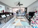 Spacious living room with hardwood floors, comfy couch, and Christmas tree at 27240 Tribune Blvd, Punta Gorda, FL 33955