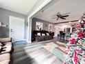 Open concept living room and kitchen with gray walls and wood-look floors at 27240 Tribune Blvd, Punta Gorda, FL 33955