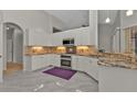 Spacious kitchen featuring granite countertops and modern appliances at 3230 Bay Ridge Way, Port Charlotte, FL 33953