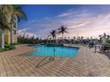 Community pool with brick pavers and lounge seating at 3340 Wood Thrush Dr # 323, Punta Gorda, FL 33950