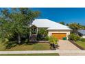 Charming home with a well-manicured lawn, brick driveway, and attached two-car garage in a sunny neighborhood at 4431 Gardner Dr, Port Charlotte, FL 33952