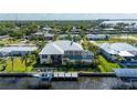 Waterfront property featuring a private pool, screened-in lanai, and personal boat dock, ideal for relaxation at 4431 Gardner Dr, Port Charlotte, FL 33952