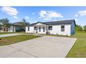 Inviting white two-story home with a paved driveway and green lawn at 9466 Tacoma Ave, Englewood, FL 34224