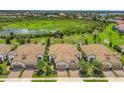 Community overview featuring several houses with tile roofs and lush green surroundings at 11137 Mcdermott Ct, Englewood, FL 34223