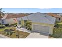 Attractive yellow house with gray roof and landscaping, showcasing curb appeal at 1766 Dunvegan Dr, Punta Gorda, FL 33980