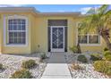 Inviting front entrance with decorative screen door and well-maintained landscaping at 1766 Dunvegan Dr, Punta Gorda, FL 33980
