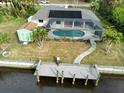 Drone view of the property showing pool, shed, dock and canal access at 18345 Ohara Dr, Port Charlotte, FL 33948