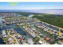An aerial view shows the neighborhood's convenient sail boat access with no bridges to the open water at 210 Divinci Dr, Punta Gorda, FL 33950
