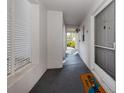 Inviting hallway with neutral tones, leading to unit entrance with a 'Welcome' mat at 437 Cerromar Ln # 312, Venice, FL 34293