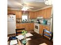 Bright kitchen with wood cabinets, appliances, and dining area at 525 Parkwood Ave, North Port, FL 34287