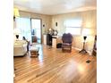 Cozy living room with wood-look floors, natural light, and traditional furniture at 525 Parkwood Ave, North Port, FL 34287